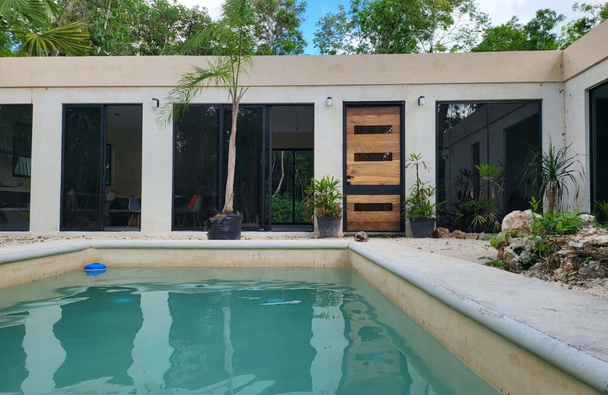 Luxury house with private pool, Green views, clubhouse with sports fields, in gated community Aqua, Cancun, for sale.