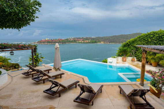 Mediterranean-style villa oceanfront with pool and green areas, for sale