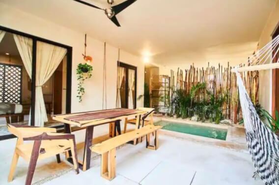 Condo with private pool, outdoor dining, solar panels, surrounded by green, yoga area, in region 15 of Tulum, for sale.